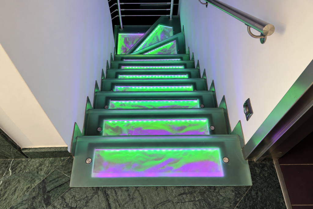 Glass Staircase Lighting Glass stair treads with green and purple LED lighting
