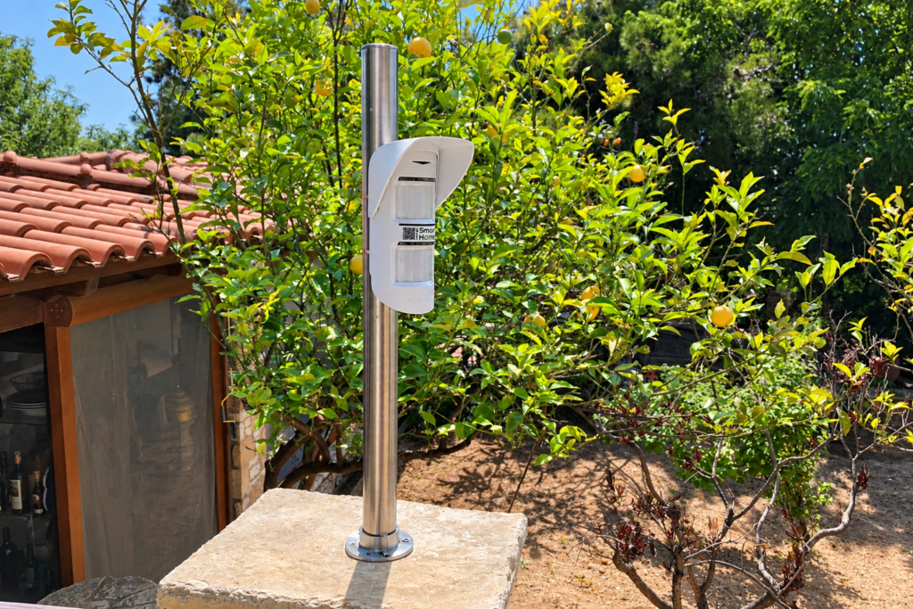 Garden Alarm Detector AJAX outdoor detector mounted on a metal post in the garden