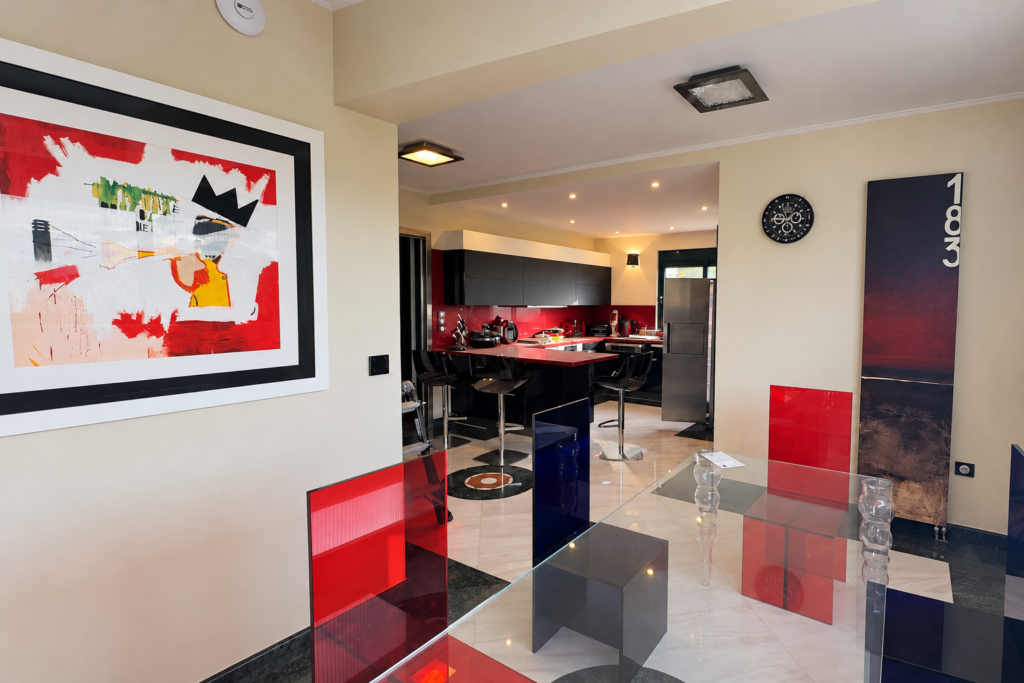 Residence Kitchen and Dining Area Dining area with red chairs beside an open kitchen